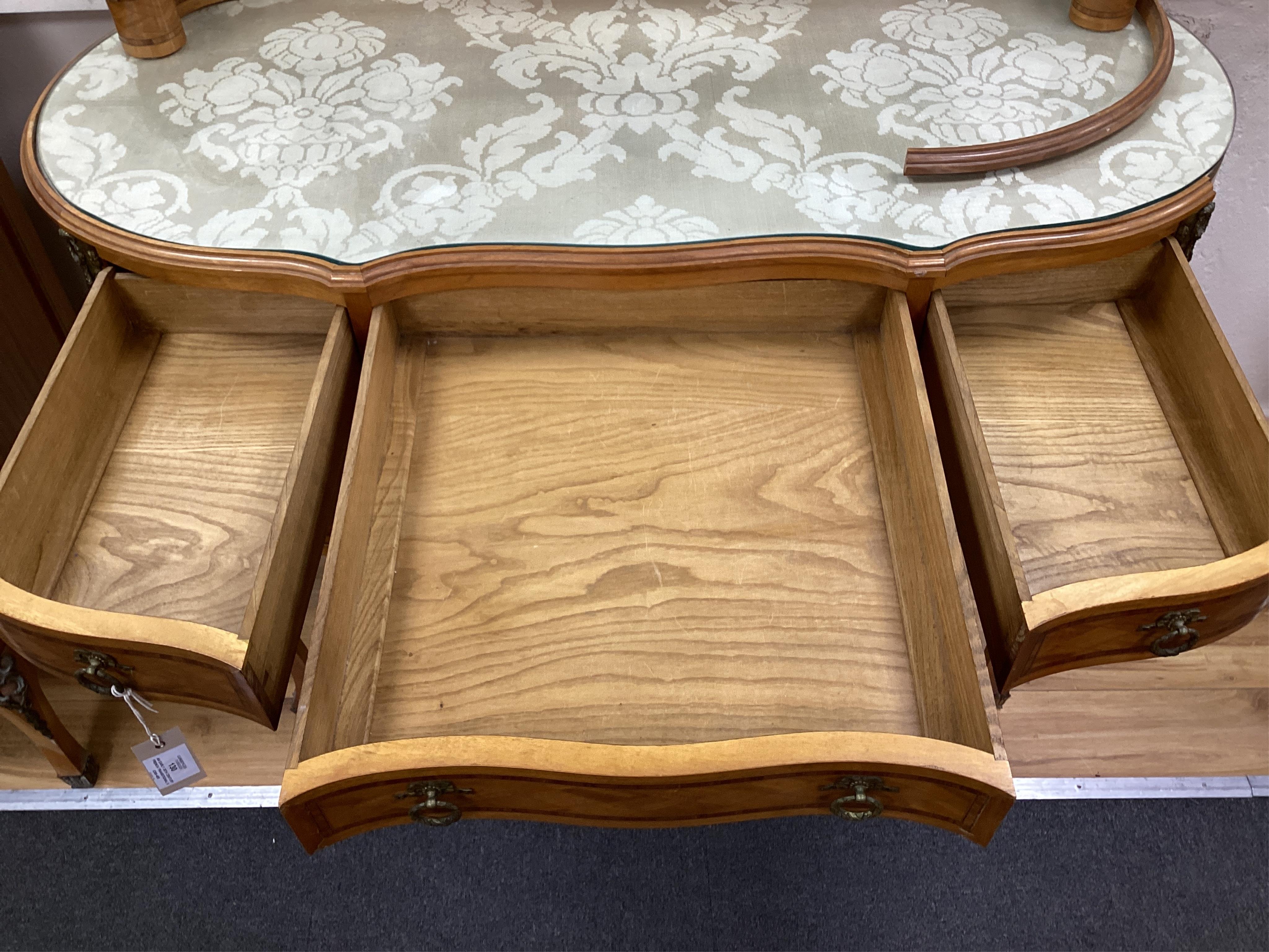An early 20th century French transitional style gilt metal mounted tulip banded and parquetry inlaid kneehole dressing table, width 115cm, depth 50cm, height 160cm